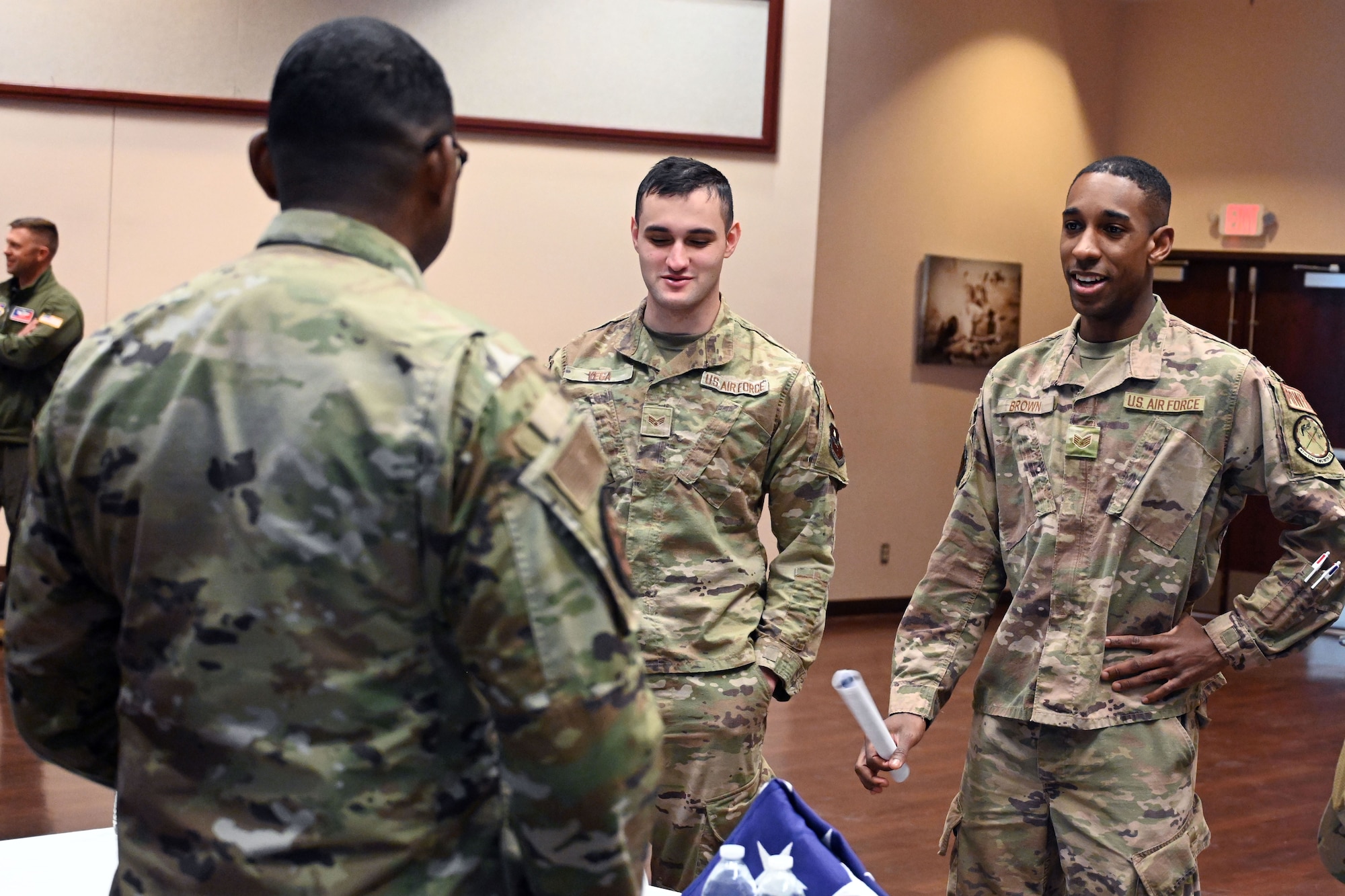 From left, Staff Sgt. Corey Smith, 97th Force Support Squadron honor guard noncommissioned officer in charge, speaks with Senior Airman Isaiah Vega and Staff Sgt. Marquis Brown, 97th Civil Engineer Squadron (CES) electrical power production journeymen, at a developmental special duties fair at Altus Air Force Base, Oklahoma, March 2, 2023. Smith talked with Airmen about future opportunities with the honor guard and recent changes to policies affecting honor guardsmen. (U.S. Air Force photo by Master Sgt. Nathan Allen)