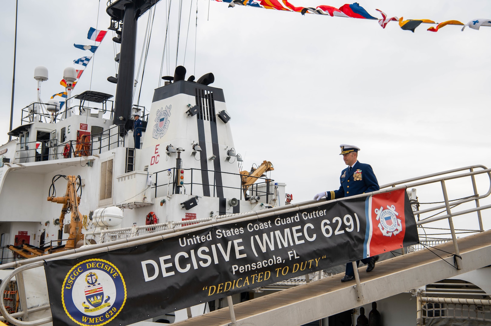Cmdr. Aaron W. Delano-Johnson, commanding officer of Coast Guard Cutter Decisive, disembarks Decisive during its decommissioning ceremony at Pensacola, Florida, March 2, 2023. The decommissioning ceremony marked the retirement of Decisive as a unit of the operating forces of the U.S. Coast Guard. (U.S. Coast Guard photo by Petty Officer 2nd Class Jose Hernandez)