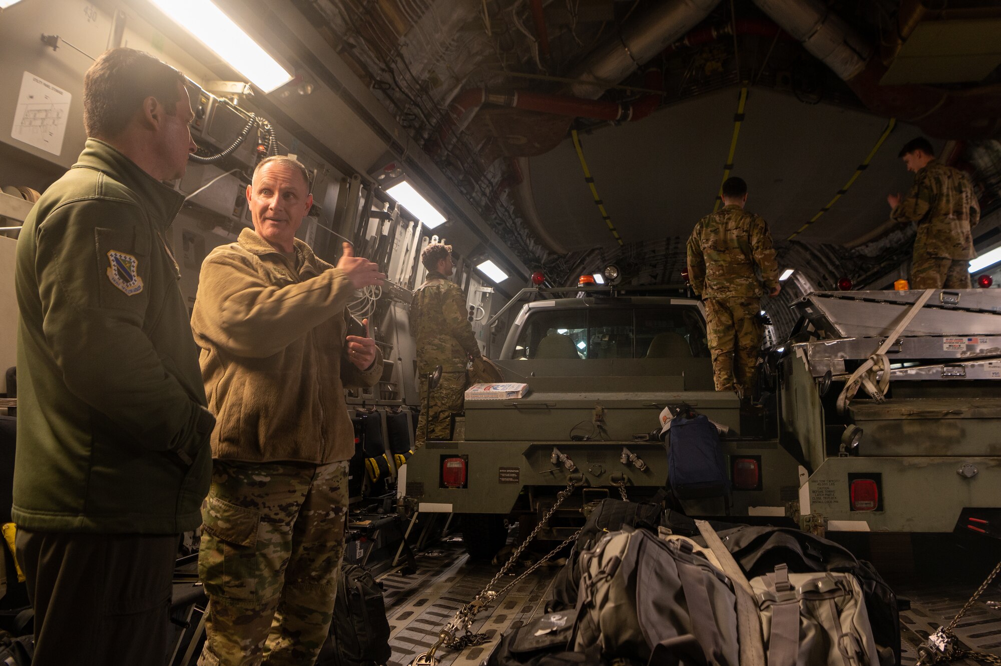 A photo of Airmen discussing operations inside of a C-17