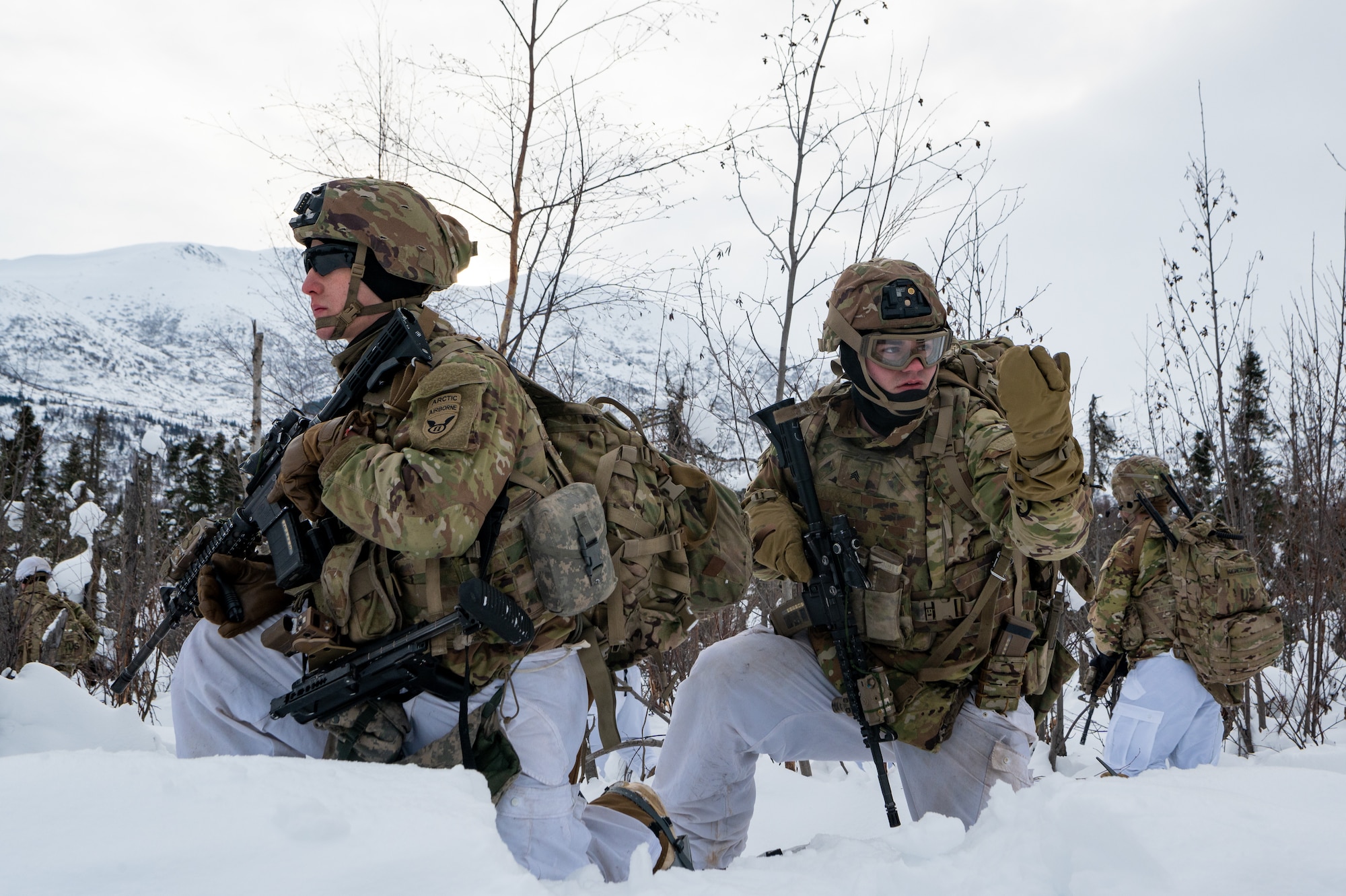 A photo of Soldiers holding watch in the snow