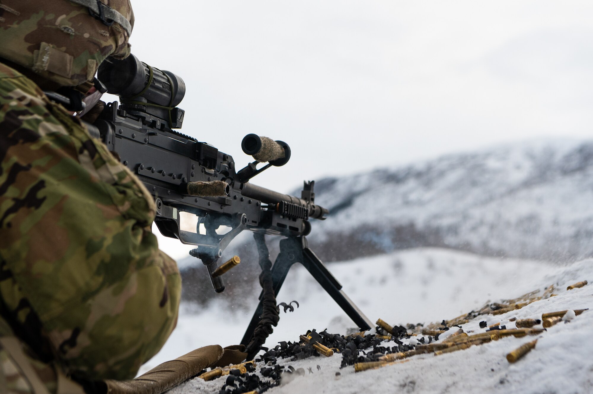 A photo of a soldier firing a machine gun