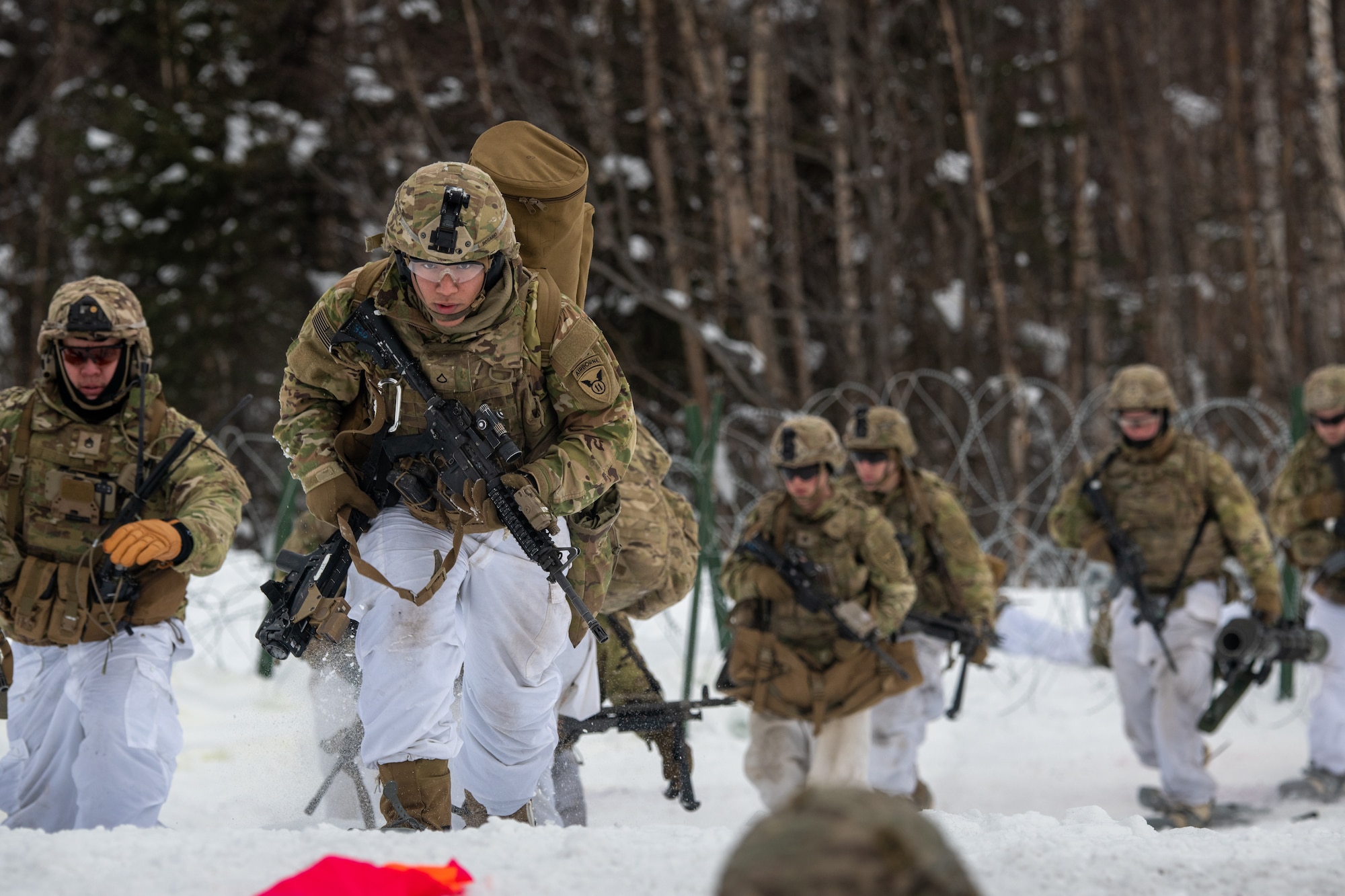 A photo of a group of soldiers advancing through the snow