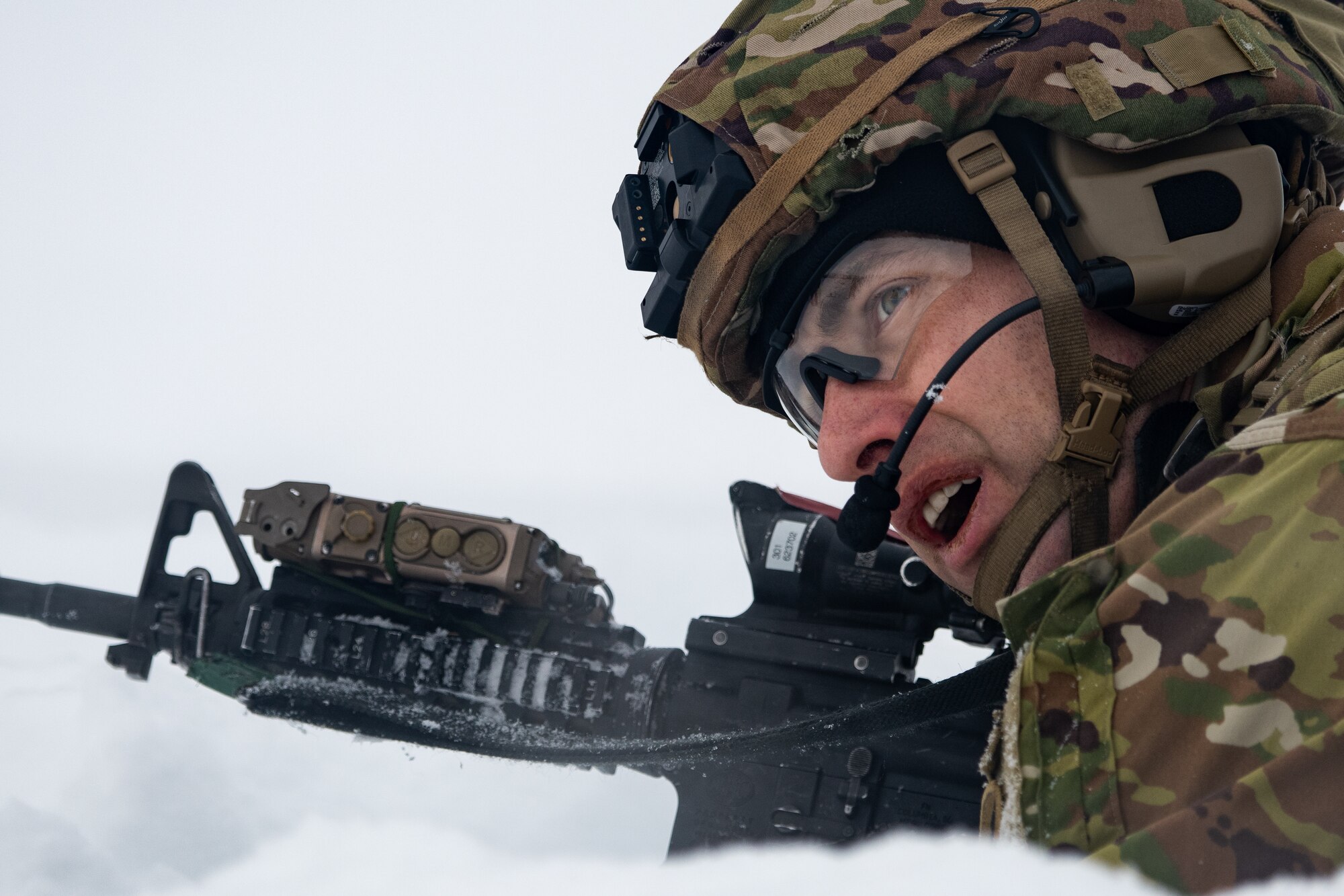 A photo of a soldier prone in the snow
