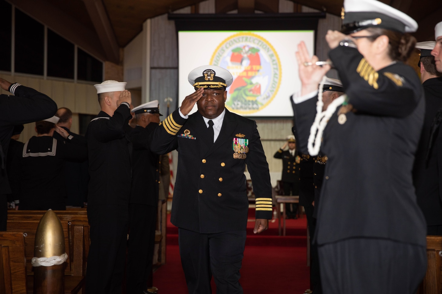Amphibious Construction Battalion TWO (ACB2) Commanding Officer, Capt. Atiim Senthill, salutes as he passes through sideboys to close out the ACB2 decommissioning ceremony, March 2, 2023.