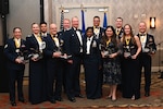 Award recipients of the 433rd Airlift Wing annual awards pose for a photo with Col. Terry W. McClain, 433rd AW commander, center left, and Chief Master Sgt. Takesha S. Williams, 433rd AW command chief, center right, during the 2022 Annual Awards Banquet at the San Antonio Marriott Northwest, Feb. 4, 2023.(U.S. Air Force photo by Staff Sgt. Adriana Barrientos)