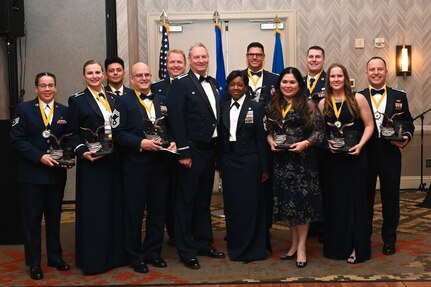 Award recipients of the 433rd Airlift Wing annual awards pose for a photo with Col. Terry W. McClain, 433rd AW commander, center left, and Chief Master Sgt. Takesha S. Williams, 433rd AW command chief, center right, during the 2022 Annual Awards Banquet at the San Antonio Marriott Northwest, Feb. 4, 2023.(U.S. Air Force photo by Staff Sgt. Adriana Barrientos)
