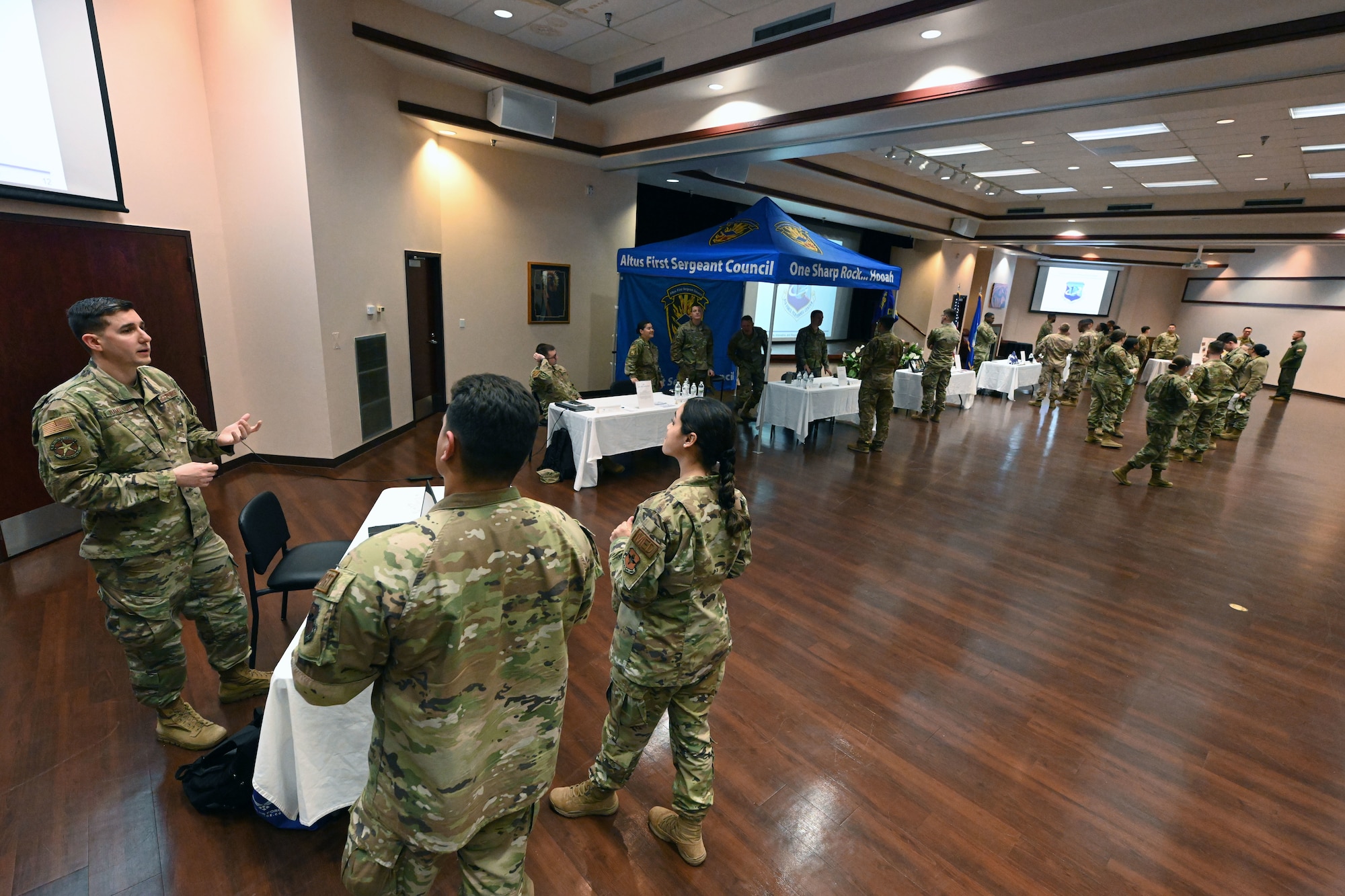 Airmen talk with each other at a developmental special duties fair at Altus Air Force Base, Oklahoma, March 2, 2023. Airmen who formerly served in a special duty attended the event to pass on knowledge to others interested in various career paths. (U.S. Air Force photo by Master Sgt. Nathan Allen)