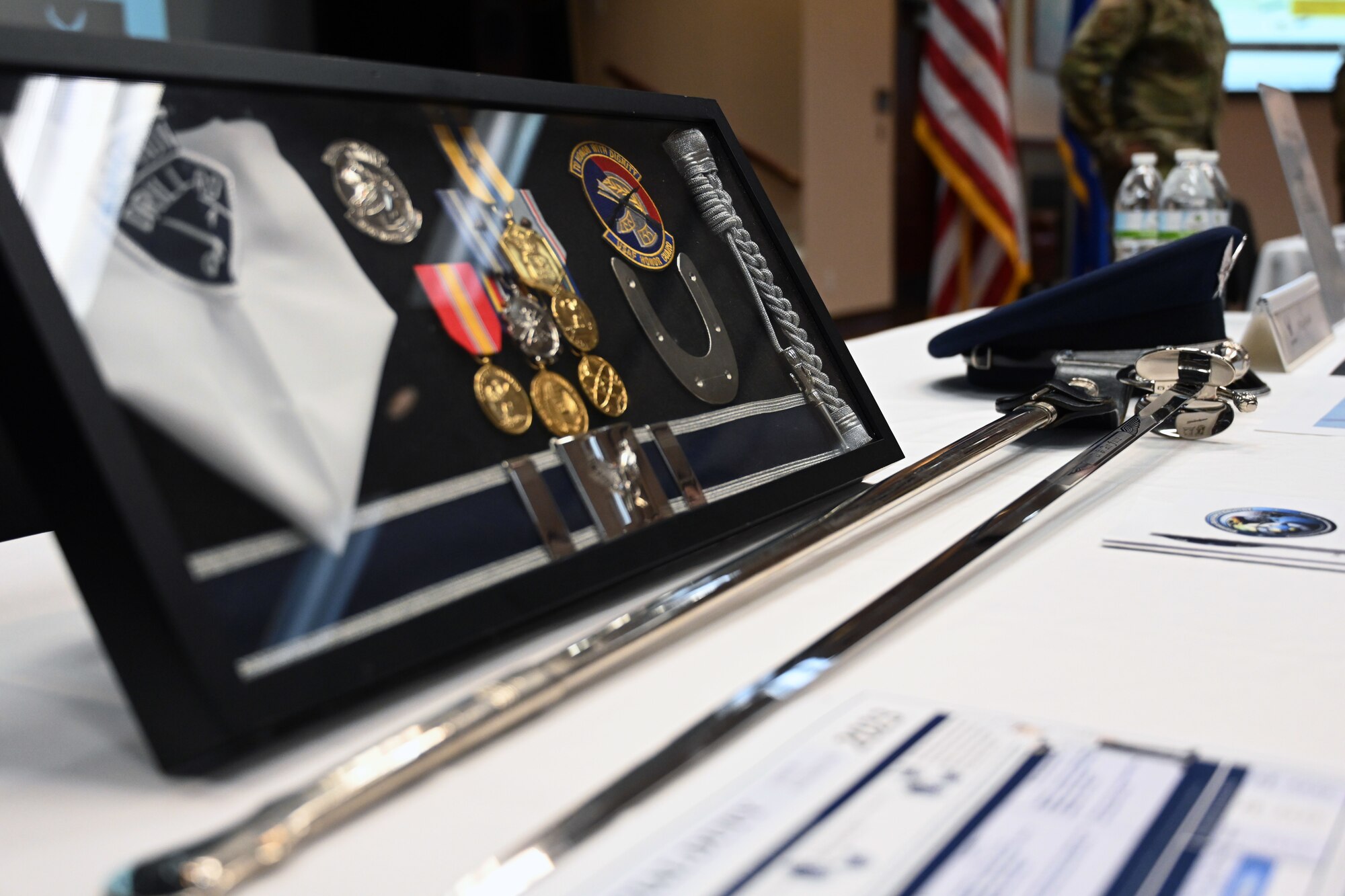 Artifacts used by honor guardsmen are displayed at a developmental special duties fair at Altus Air Force Base, Oklahoma, March 2, 2023. Recruiters, first sergeants, military training leaders, and more attended the event to serve as subject matter experts for Airmen considering alternate career paths. (U.S. Air Force photo by Master Sgt. Nathan Allen)