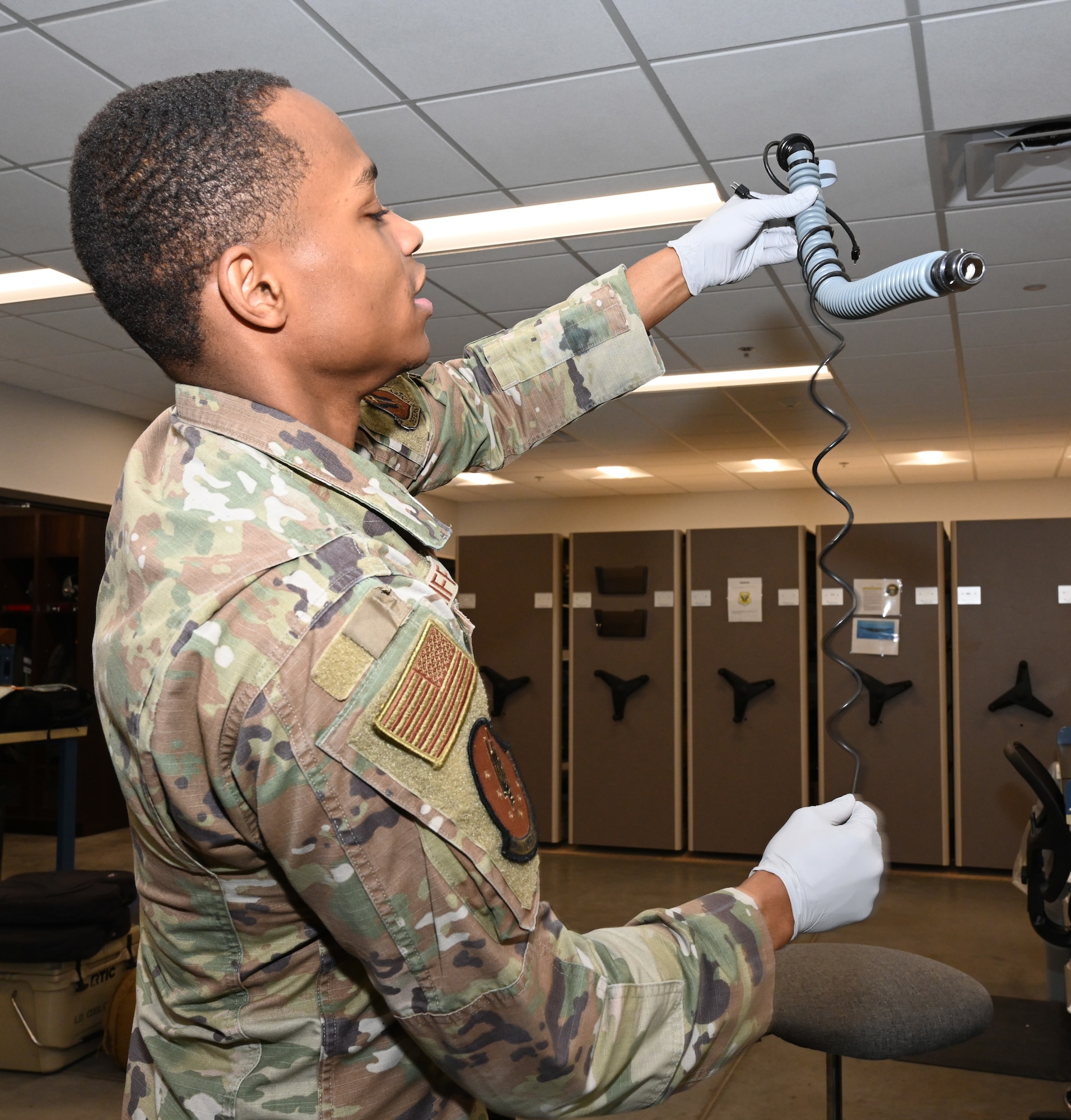 Senior Airman Anthony Ratliff an Aircrew Flight Equipment journeyman assigned to the 509th Operations Support Squadron, speaks about conducting a routine inspection on an aircrew member’s HGU-55p helmet and MBU-20p mask at Whiteman Air Force Base, Missouri, Feb. 13, 2023. Aircrew Flight Equipment specialists make sure Airmen have the supplies necessary for any situation. (U.S. Air Force photo by Airman 1st Class Hailey Farrell)