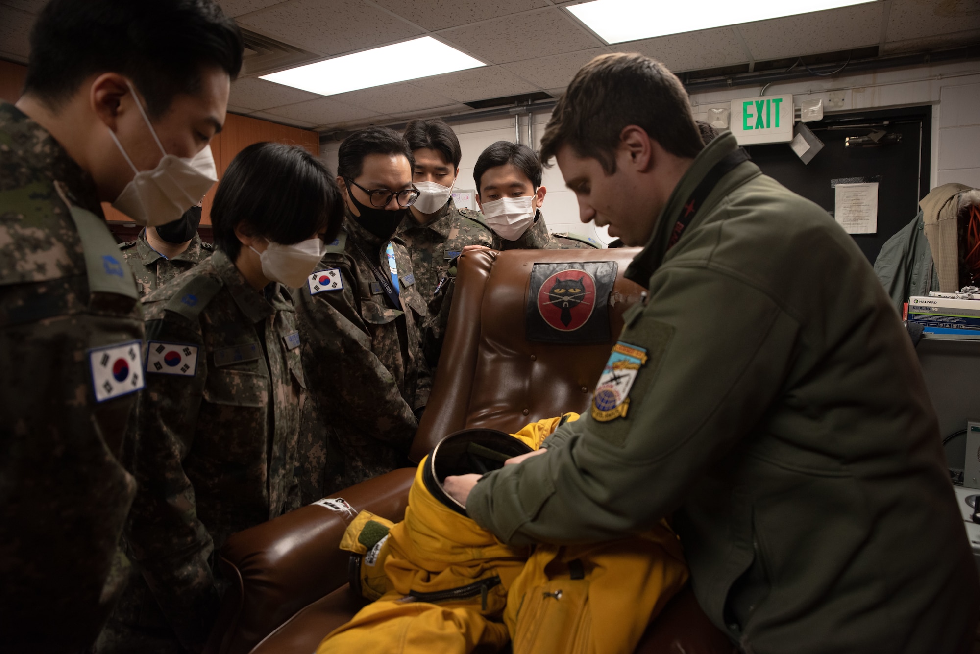 U.S. Air Force Capt. Ben Scott, U-2 instructor pilot, shows Republic of Korea Air Force interpretation officers in training a U-2S Dragon Lady flight suit during an immersion tour at Osan Air Base, ROK, Feb. 23, 2023.