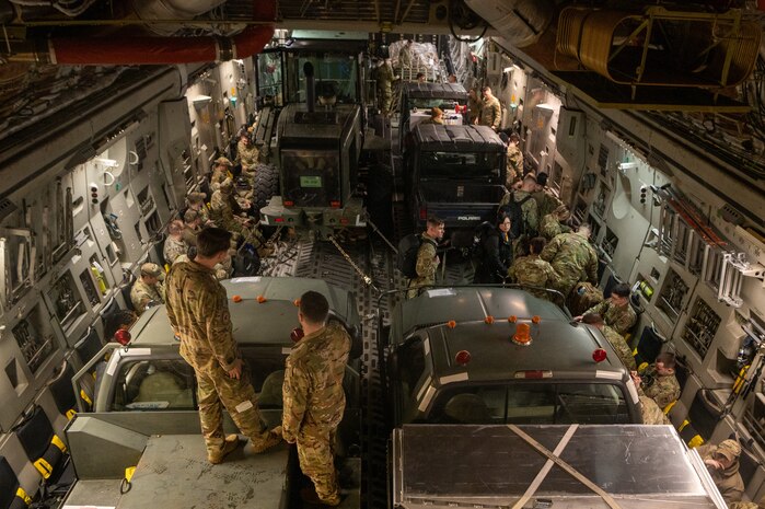 A photo of a C-17 filled with cargo and Airmen