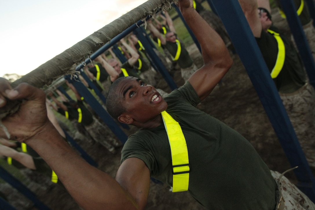 Rct. Tyler Alleyne, Platoon 3080, India Company, 3rd Recruit Training Battalion, struggles to pull his chin over the bar during a physical training session Aug. 21, 2013, on Parris Island, S.C. Physical training sessions are meant to help recruits prepare for their physical fitness and combat fitness tests, which are both graduation requirements. Alleyne, 18, from Spartanburg, S.C., is scheduled to graduate Oct. 25, 2013. Parris Island has been the site of Marine Corps recruit training since Nov. 1, 1915. Today, approximately 20,000 recruits come to Parris Island annually for the chance to become United States Marines by enduring 13 weeks of rigorous, transformative training. Parris Island is home to entry-level enlisted training for 50 percent of males and 100 percent for females in the Marine Corps. (U.S. Marine Corps photo by Cpl. Caitlin Brink)
