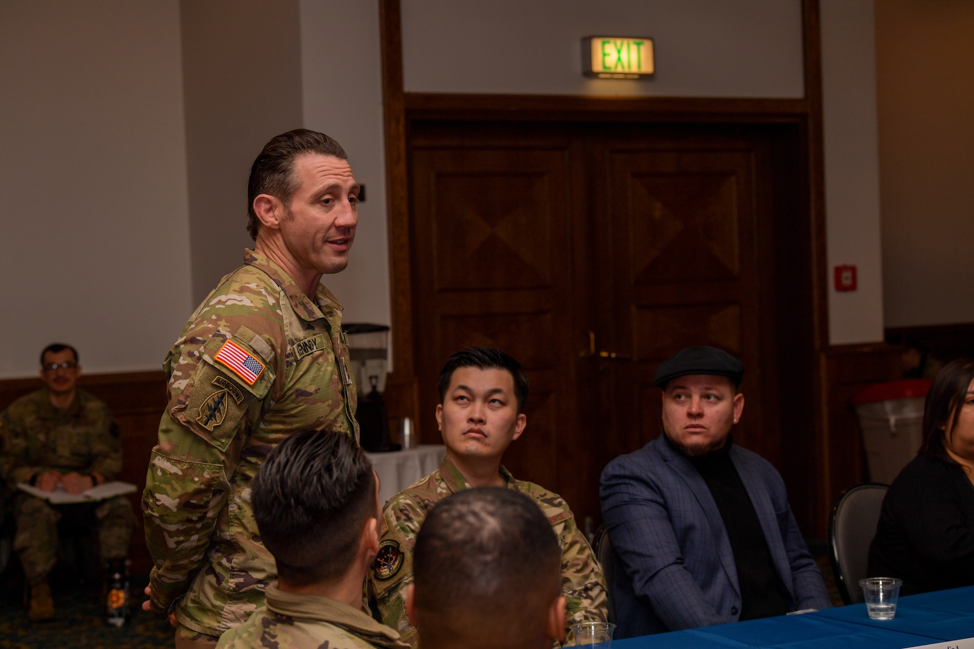 U.S. Army National Guard Master Sgt. Tim Kennedy, Special Forces Operations Sgt., addresses Airmen, civilians and spouses during a round-table discussion at Ramstein Air Base, Germany, March 1, 2023.