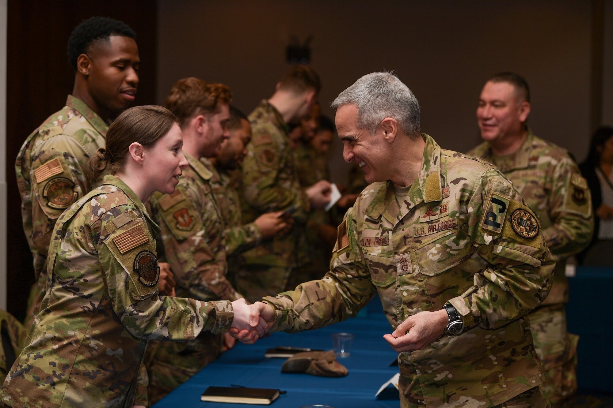 Senior Enlisted Advisor to the Chairman Ramon “CZ” Colon-Lopez, coins Airmen during a personnel and readiness visit to Ramstein Air Base, Germany, March 1, 2023.