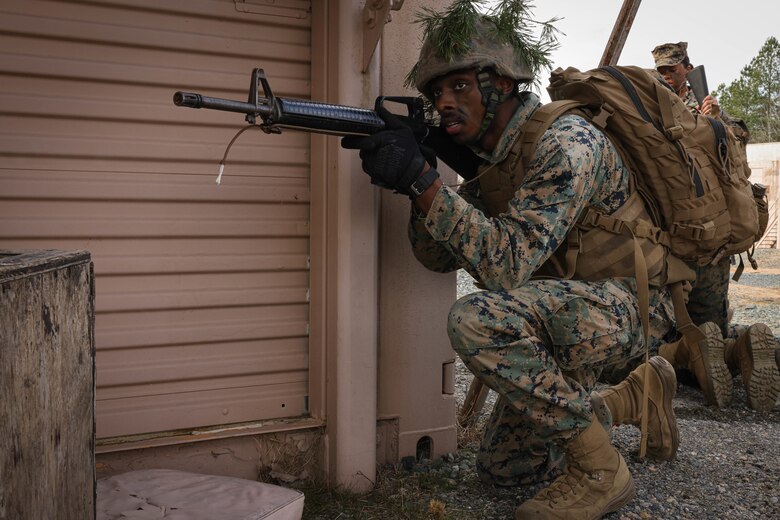 U.S. Marine Corps Cpl. Kenneth Burchette Jr, a motor vehicle operator with The Basic School, holds security while on a simulated urban patrol during a joint Corporals course, class 1-23, hosted by Headquarters Battalion, Training and Education Command, and Security Battalion on Marine Corps Base Quantico, Virginia, Feb. 10, 2023. The Small Unit Leadership Evaluation event’s purpose is to test the students on material covered during the course, using practical application to develop critical thinking skills. (U.S. Marine Corps photo by Lance Cpl. David Brandes)