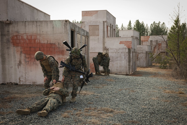 U.S. Marines evacuate a simulated casualty while on an urban patrol exercise during a joint Corporals course, class 1-23, hosted by Headquarters Battalion, Training and Education Command, and Security Battalion on Marine Corps Base Quantico, Virginia, Feb. 10, 2023. The Small Unit Leadership Evaluation event’s purpose is to test the students on material covered during the course, using practical application to develop critical thinking skills. (U.S. Marine Corps photo by Lance Cpl. David Brandes)