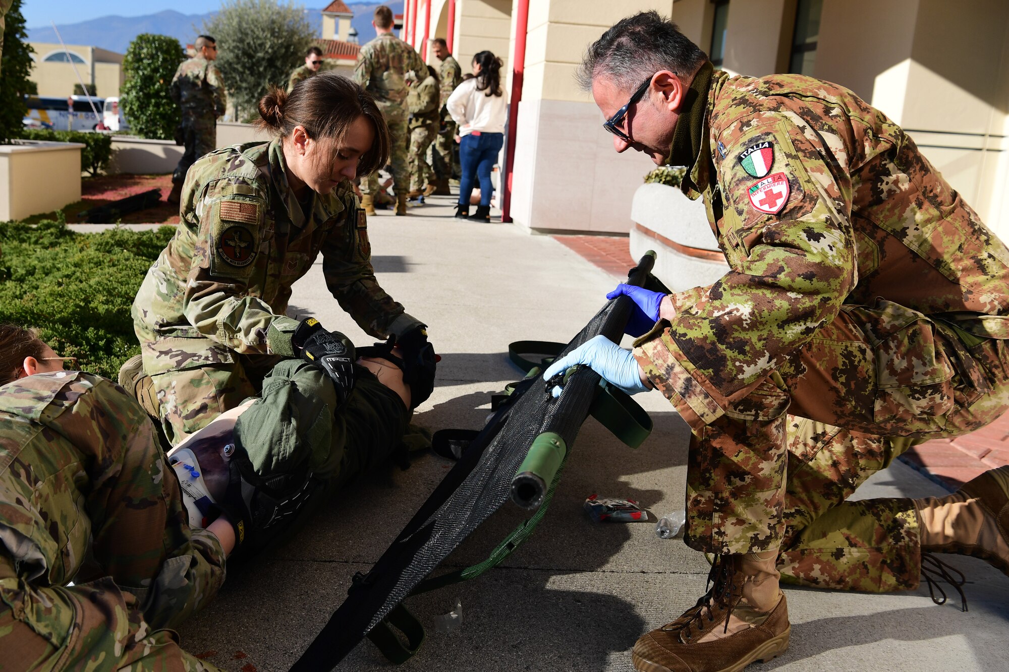 U.S. Airmen from the 31st Medical Group and Italian Air Force medical personnel simulate transporting injured patients during a joint training event at Aviano Air Base, Italy, Feb. 14, 2023.