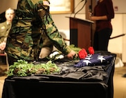A veteran lays a rose in honor of the 18 service members from the state of Illinois who passed away while serving in Operations Desert Shield and Desert Storm. The ceremony took place Feb. 28 at the Illinois State Military Museum in Springfield. February 28, 2023, marks the 32nd anniversary of the cease fire announcement of the Persian Gulf War. (U.S. Army photo by Sgt. Trenton Fouche, Joint Force Headquarters - Illinois National Guard)