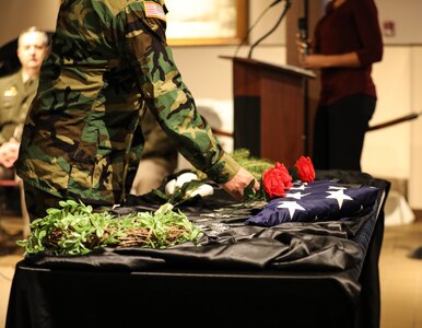 A veteran lays a rose in honor of the 18 service members from the state of Illinois who passed away while serving in Operations Desert Shield and Desert Storm. The ceremony took place Feb. 28 at the Illinois State Military Museum in Springfield. February 28, 2023, marks the 32nd anniversary of the cease fire announcement of the Persian Gulf War. (U.S. Army photo by Sgt. Trenton Fouche, Joint Force Headquarters - Illinois National Guard)