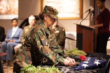 U.S. Air Force Master Sgt. (retired) Rosemary Connolly, lays a rose in honor of the 18 service members from the state of Illinois who passed away while serving in Operations Desert Shield and Desert Storm. The ceremony took place Feb. 28 at the Illinois State Military Museum in Springfield. February 28, 2023, marks the 32nd anniversary of the cease fire announcement of the Persian Gulf War. (U.S. Army photo by Sgt. Trenton Fouche, Joint Force Headquarters - Illinois National Guard)