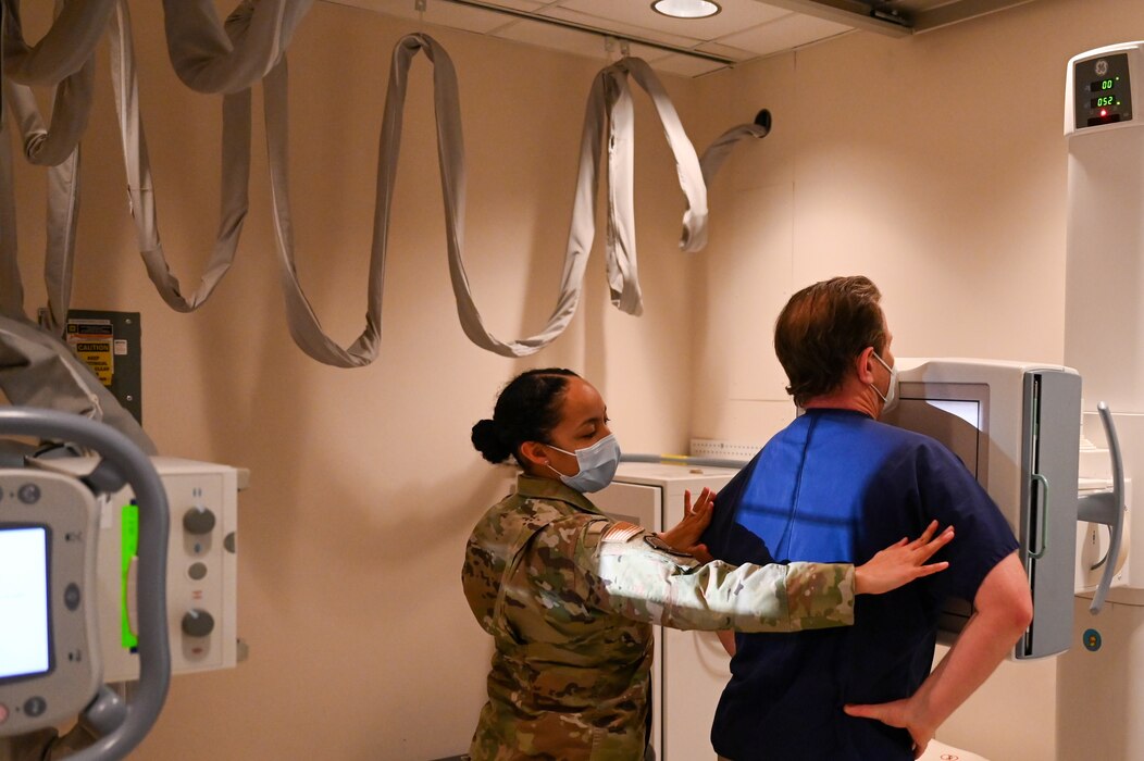 Image of an Airman treating a patient.