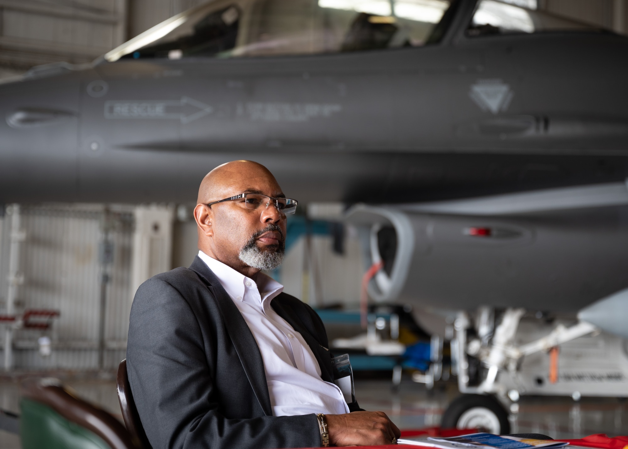 Barney Gadson sits in front of F-16C Fighting Falcon