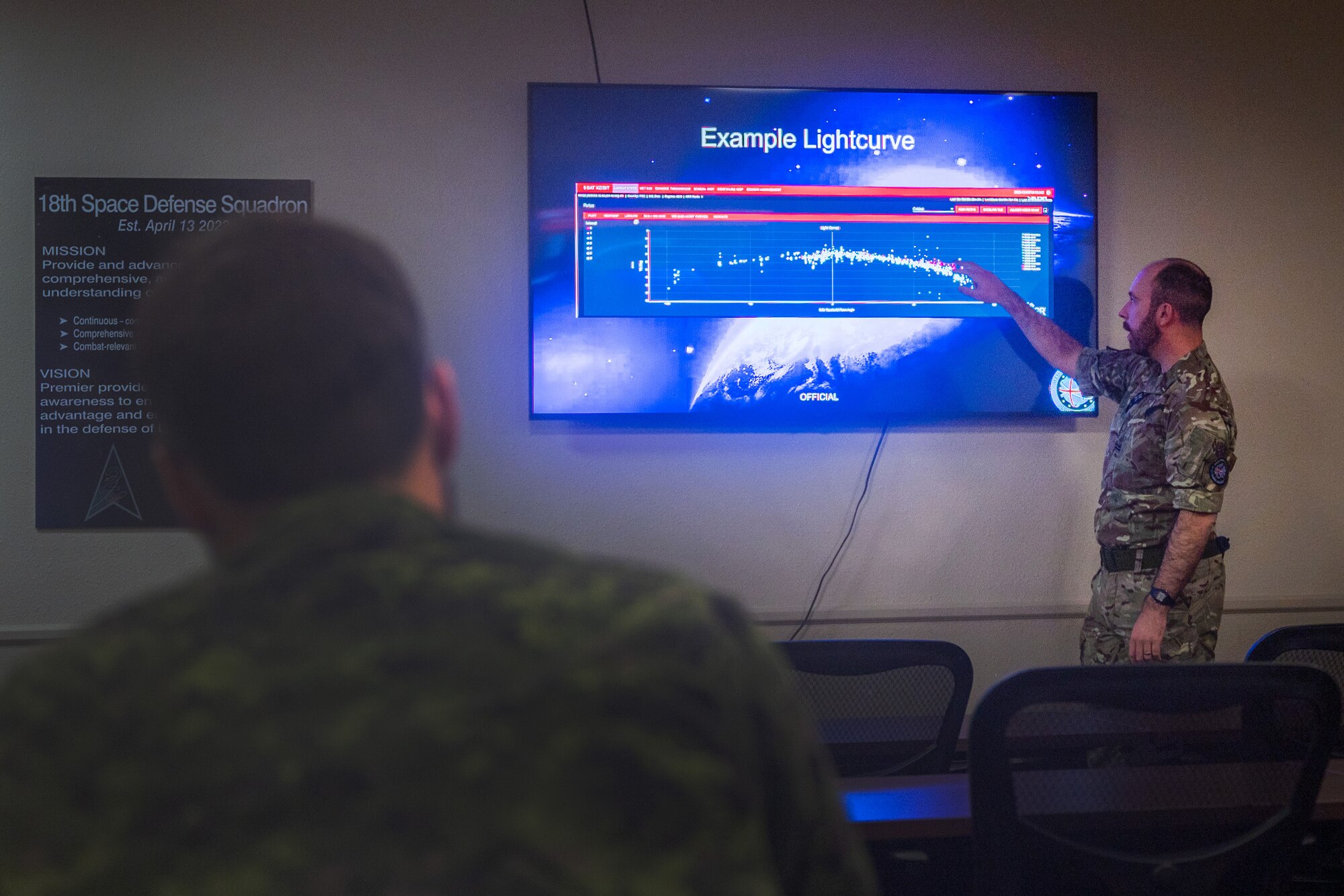 Royal Air Force (RAF) Flying Officer Hallchurch, U.K. Space Operations Centre (UKSpOC) space duty officer, briefs members of the 18th Space Defense Squadron during the first day of the Operator Exchange program at Vandenberg Space Force Base, Calif., Feb. 13, 2023. The U.K. was the first state to publicly join the U.S. led Operation Olympic Defender – an effort to enable international sharing of space resources and the synchronization of space efforts aimed at strengthening allies abilities to deter hostile actions by rivals. (U.S. Space Force photo by Tech. Sgt. Luke Kitterman)