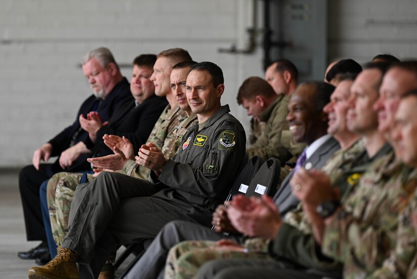 U.S. Air Force Col. Tyler Ellison, 1st Fighter Wing vice commander, applauds during a speech at the F-22 Consolidation Operations Maintenance Hanger ceremony at Joint Base Langley-Eustis, Virginia, Feb. 22, 2023.