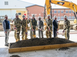 JBLE leaders and community members hold shovels to celebrate the beginning of the COMH project.