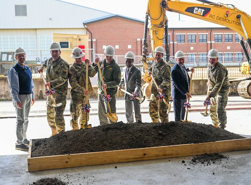 JBLE leaders and community members hold shovels to celebrate the beginning of the COMH project.