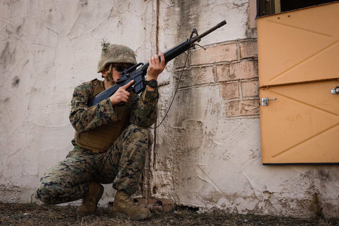 U.S. Marine Corps Cpl. Filip Kowalski, a motor vehicle operator with The Basic School, holds security while on a simulated urban patrol during a joint Corporals course, class 1-23, hosted by Headquarters Battalion, Training and Education Command, and Security Battalion on Marine Corps Base Quantico, Virginia, Feb. 10, 2023. The Small Unit Leadership Evaluation event’s purpose is to test the students on material covered during the course, using practical application to develop critical thinking skills.
