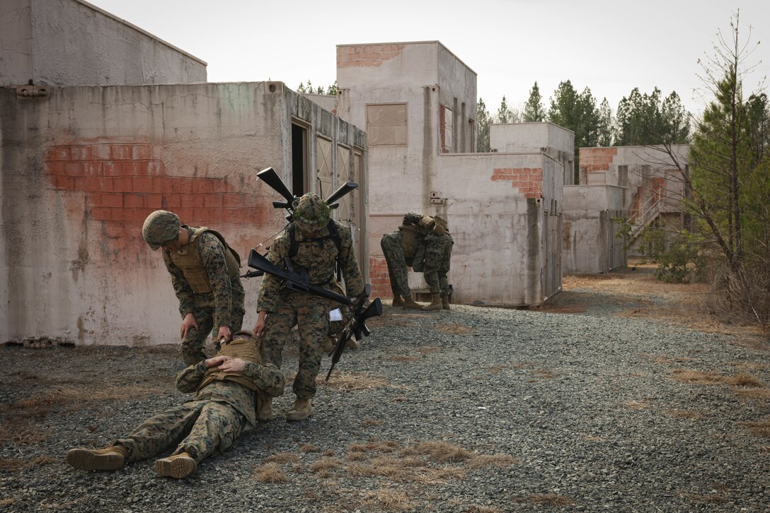 U.S. Marines evacuate a simulated casualty while on an urban patrol exercise during a joint Corporals course, class 1-23, hosted by Headquarters Battalion, Training and Education Command, and Security Battalion on Marine Corps Base Quantico, Virginia, Feb. 10, 2023. The Small Unit Leadership Evaluation event’s purpose is to test the students on material covered during the course, using practical application to develop critical thinking skills.