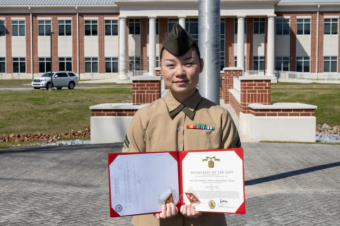 U.S. Marine Corps Cpl. Grace Roman, an imagery-analysis specialist with Marine Wing Headquarters Squadron (MWHS) 2, poses for photo after receiving the Navy and Marine Corps Achievement Medal at Marine Corps Air Station Cherry Point, North Carolina, Feb. 24, 2023. Roman was recognized as the 2nd Marine Aircraft Wing (MAW) 2022 Marine of the Year for her exemplary work during Exercise Cold Response 2022 and other operations across Europe. MWHS-2 is a subordinate unit of 2nd MAW, the aviation combat element of II Marine Expeditionary Force. (U.S. Marine Corps photo by Sgt. Servante R. Coba)