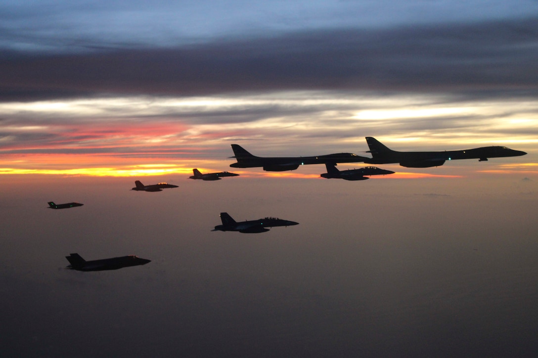 Aircraft fly in formation.