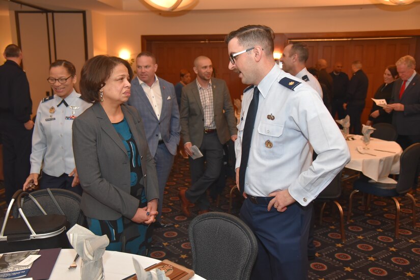 Avis McMillon, left, College of Southern Maryland associate vice president of marketing and communication, speaks with Maj. James Nardelli, 316th Force Support Squadron commander, at the Honorary Commander Induction at Joint Base Andrews, Md., March 2, 2023. McMillon was one of 16 new honorary commanders recognized during the ceremony, and she is paired with Nardelli in the program. (Photo courtesy of Patrick Griffith)