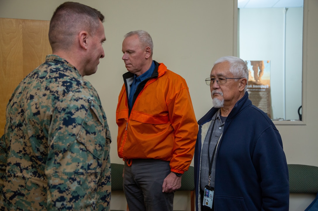 U.S. Marine Corps Col. Donald Harlow, left, commanding officer, Marine Force Storage Command, Marine Corps Logistics Command, awards the Civilian Commendation Medal to Dan Corte-Real, right, regional project manager for the Consolidated Storage Program, II MEF Logistics Command, during a retirement ceremony at the Individual Issue Facility on Marine Corps Base Camp Lejeune, North Carolina, Feb. 8, 2023. Corte-Real retired with 54 years of dedicated service between active duty with the U.S. Navy and U.S. Marine Corps and civilian service with the Department of Defense. (U.S. Marine Corps photo by Sgt. Ginnie Lee)