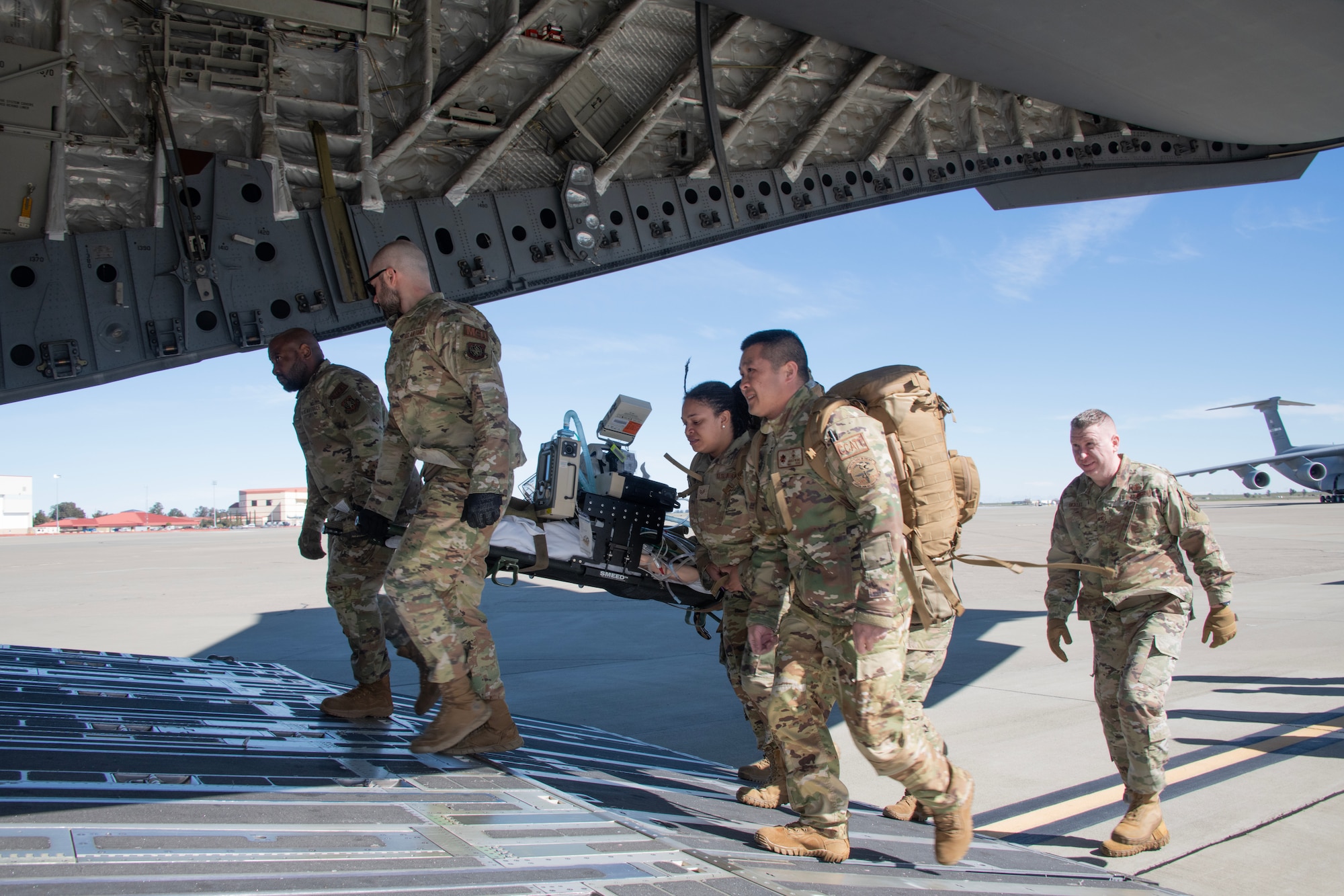 Airmen load medical mannequin on to C-17 Globe Master III aircraft