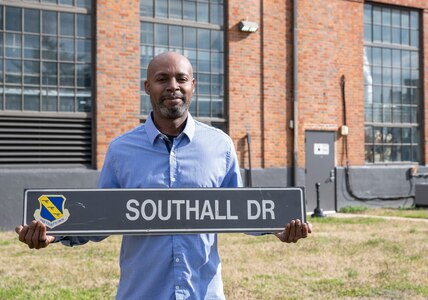 Gregory Southall, 11th Civil Engineer Squadron chief of infrastructure, holds the street sign dedicated to his family on Joint Base Anacostia-Bolling, Washington, D.C., March 1, 2023. Both Southall's grandfather, who was a Tuskegee Airman, and his mother worked on JBAB before him. Southall stated his grandfather's military service during WWII paved the way for the family's three generations of military and government work. (U.S. Air Force photo by 2nd Lt. Brandon DeBlanc)