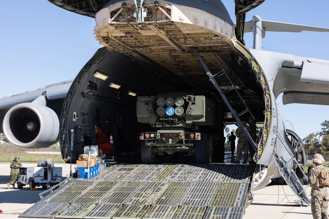 U.S. Marines with 5th Battalion, 11th Marine Regiment, 1st Marine Division, drive an M142 High Mobility Artillery Rocket System onto a U.S. Air Force C-5 Galaxy during a loading exercise at Marine Corps Air Station Camp Pendleton, California, Feb. 7, 2023.  Marines with the battalion conducted the exercise in order to rehearse the planning and execution of embarking a self-sustaining platoon on a C-5. (U.S. Marine Corps photo by Cpl. Cameron Hermanet)