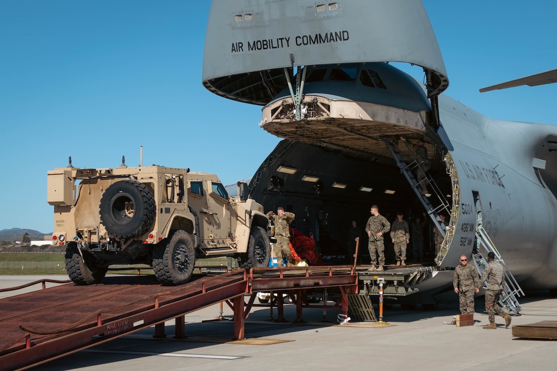 U.S. Marines with 1st Landing Support Battalion, Combat Logistics Regiment 1, 1st Marine Logistics Group, off-load a Joint Light Tactical Vehicle from a U.S. Air Force C-5 Galaxy during a Strategic Mobility Exercise at Camp Pendleton, California, Feb. 8, 2023. The goal of this evolution was to evaluate the unit’s ability to pack and stage equipment within a specified timeline, identify lift and transportation requirements, and prepare military vehicles for transportation. (U.S. Marine Corps photo by Lance Cpl. Kristy Ordonez Maldonado)