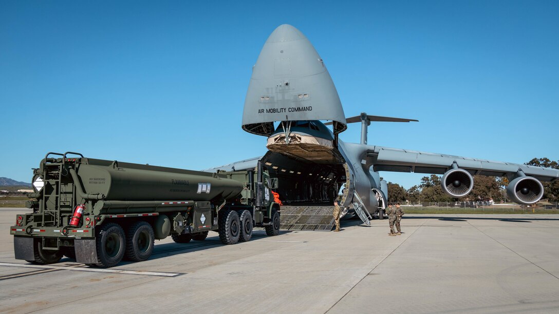 U.S. Marines with 1st Landing Support Battalion, Combat Logistics Regiment 1, 1st Marine Logistics Group, load a M-970 semi-trailer refueler onto a U.S. Air Force C-5 Galaxy during a Strategic Mobility Exercise at Camp Pendleton, California, Feb. 8, 2023. The goal of this evolution was to evaluate the unit’s ability to pack and stage equipment within a specified timeline, identify lift and transportation requirements, and prepare military vehicles for transportation. (U.S. Marine Corps photo by Lance Cpl. Kristy Ordonez Maldonado)