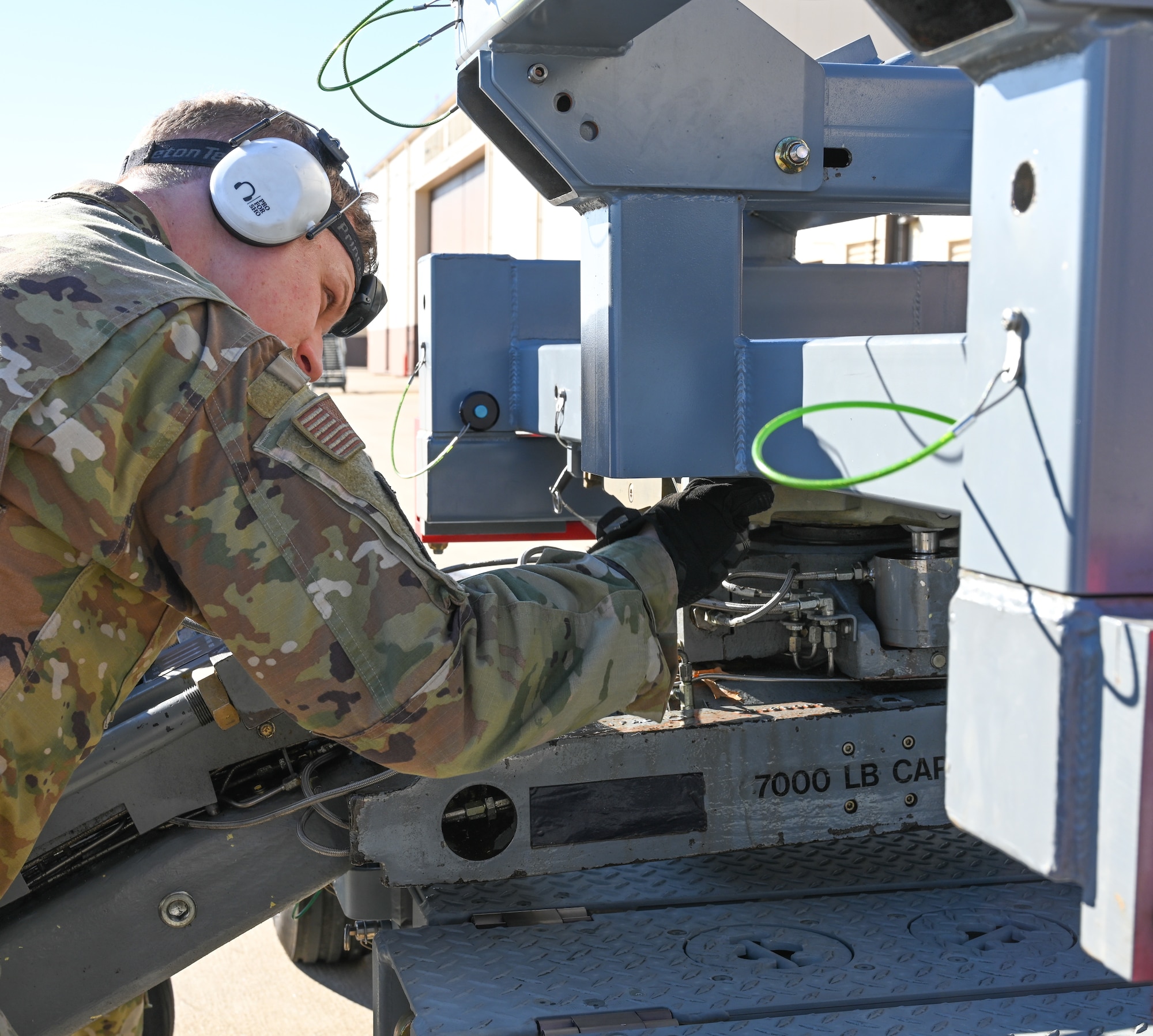 Senior Airman Jesse Papenhausen, 509th Aircraft Maintenance Squadron, weapons load crew member, participated in training on the new launcher load system at Whiteman Air Force Base, Missouri, Feb. 2, 2023. The airman connect the launcher load system adaptor to the jammer. (U.S. Air Force photo by Airman 1st Class Hailey Farrell)