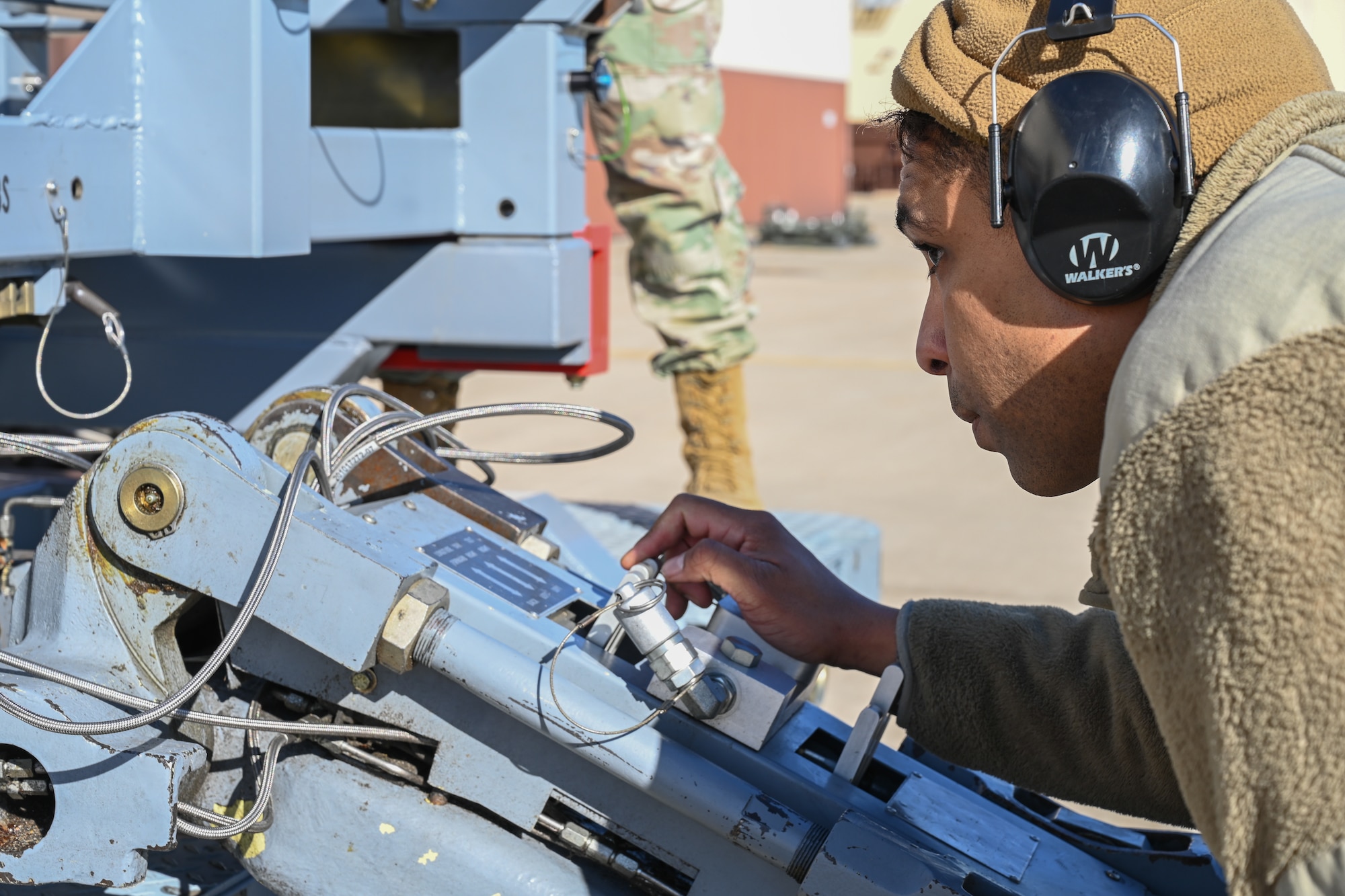 Staff Sgt. Adrian Perez, 509th Aircraft Maintenance Squadron, weapons load crew team chief, aligns the jammer to the launcher load systems (LLS) adapter at Whiteman Air Force Base, Missouri, Feb. 2, 2023. The Legacy Style load system that is normally used requires more equipment and man hours than the LLS. (U.S. Air Force photo by Airman 1st Class Hailey Farrell)