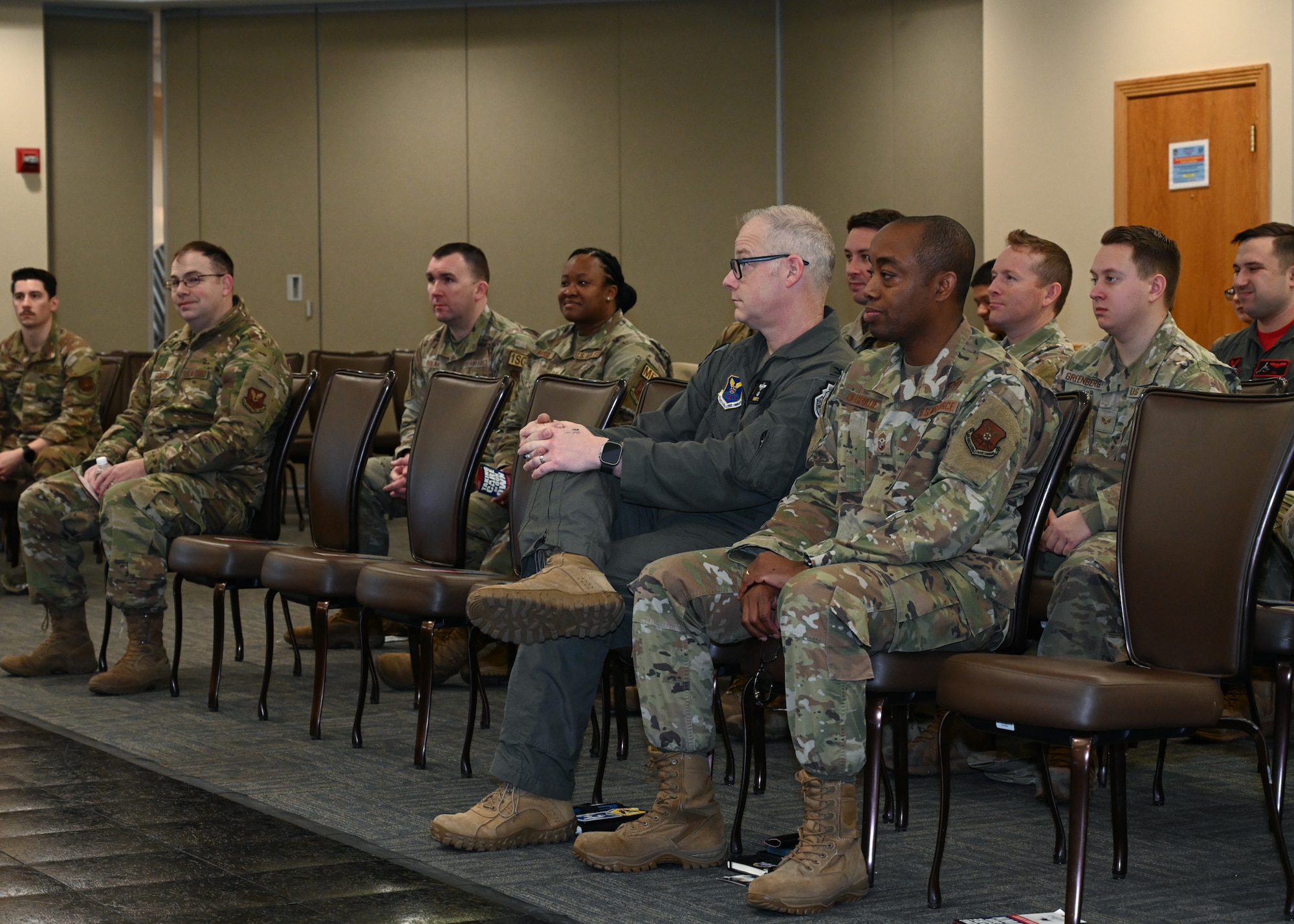 Col. Daniel Diehl, 509th Bomb Wing commander, Chief Master Sgt. Olatokunbo Olopade, 509th Bomb Wing command chief, and 509th Bomb Wing Airmen listen to ways Airmen can use the Air Force Assistance Fund at Whiteman Air Force Base, Mo., March 3, 2023. The Air Force Assistance Fund has helped Airmen by providing them with assistance when times in their life are difficult. (U.S. Air Force photo by Senior Airman Nash Truitt)