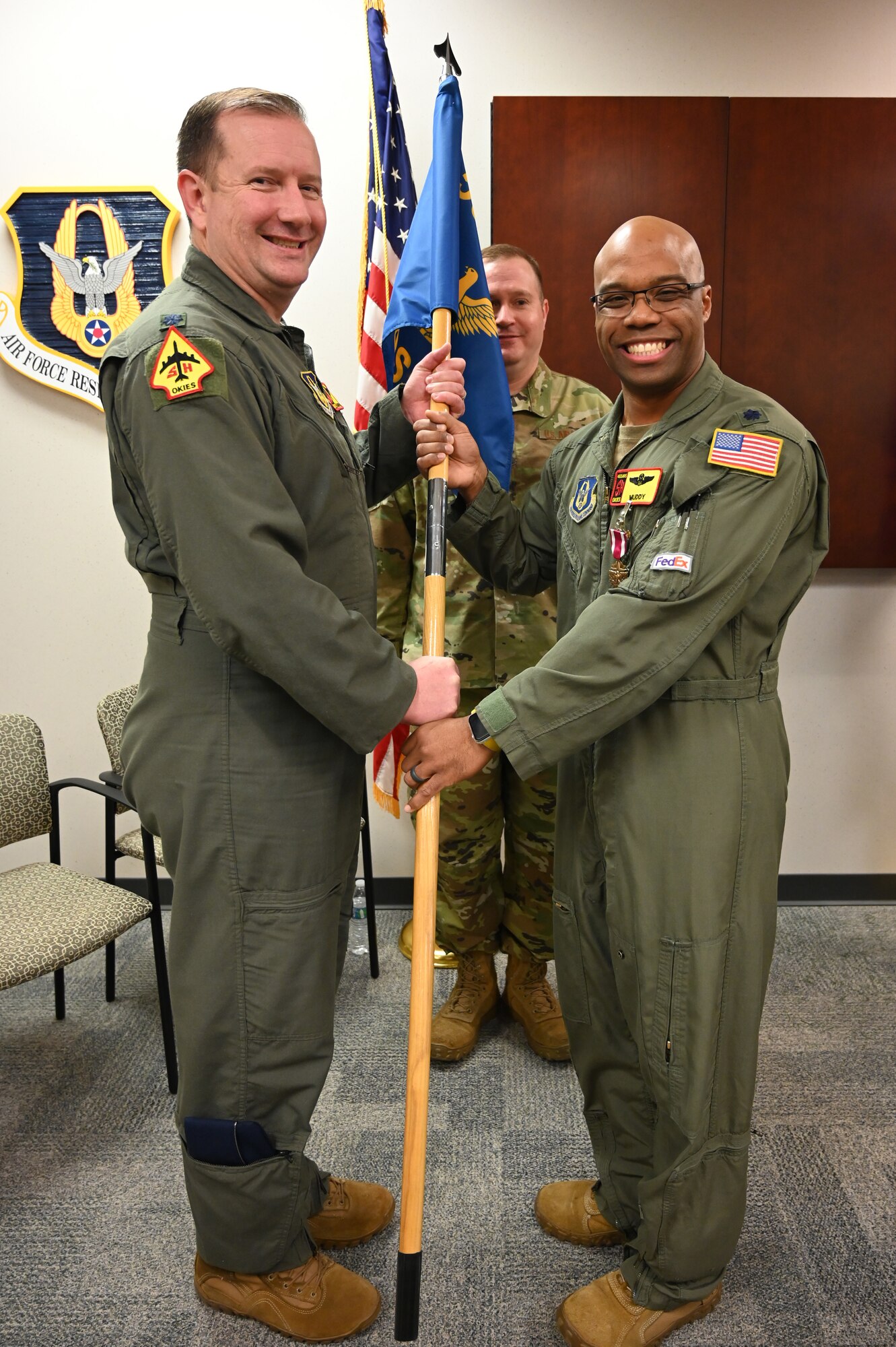 two men holding a flag