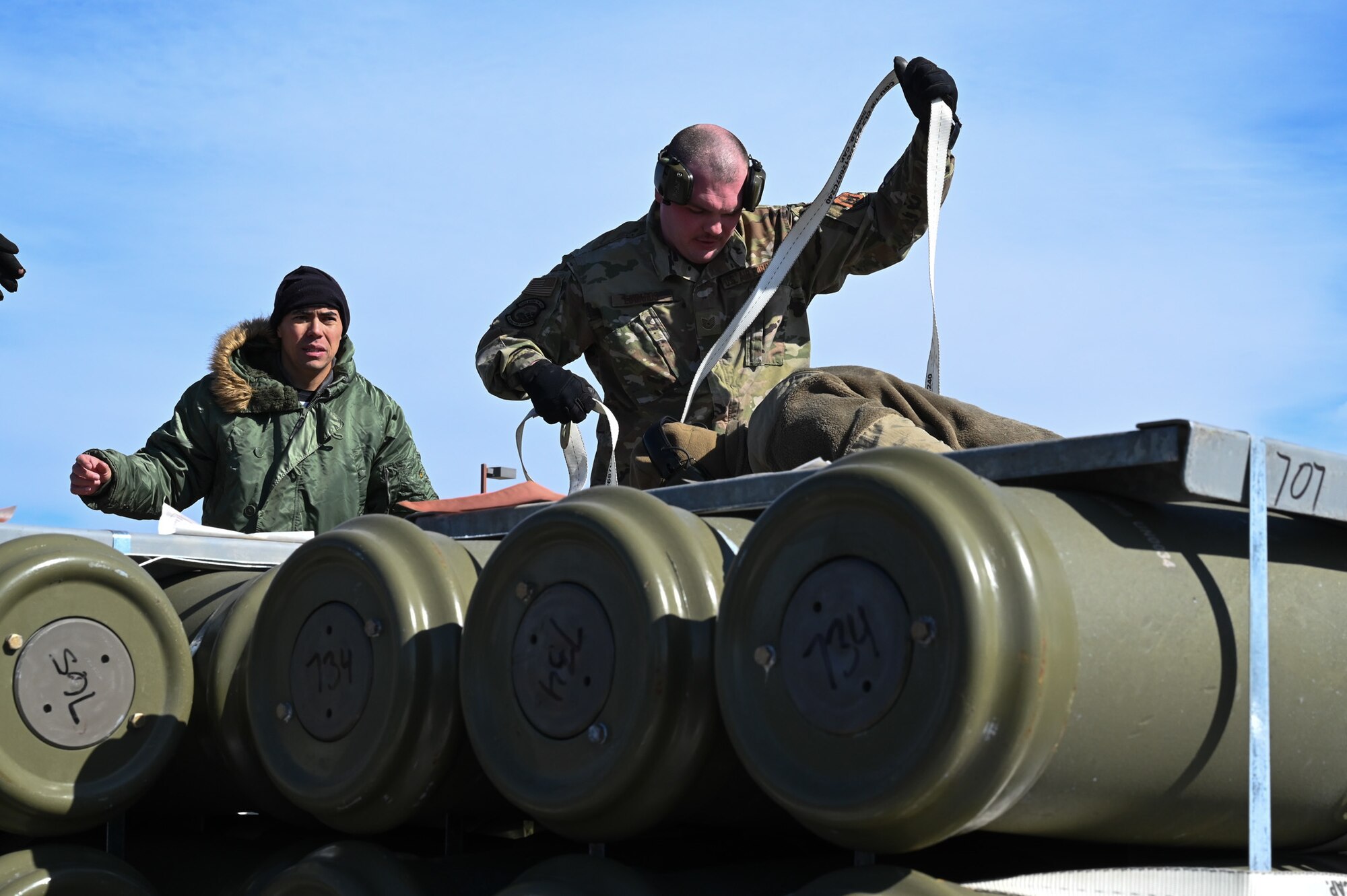 airman tying down munitions