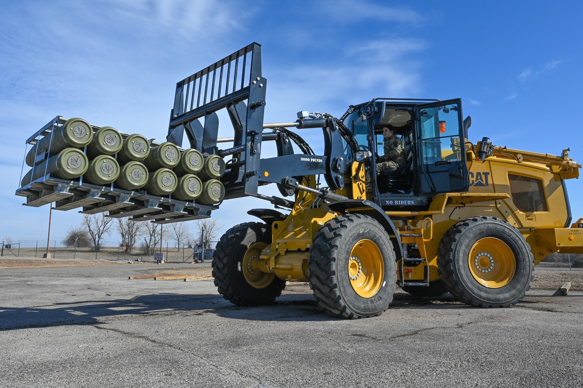 airman driving forklift with munitions