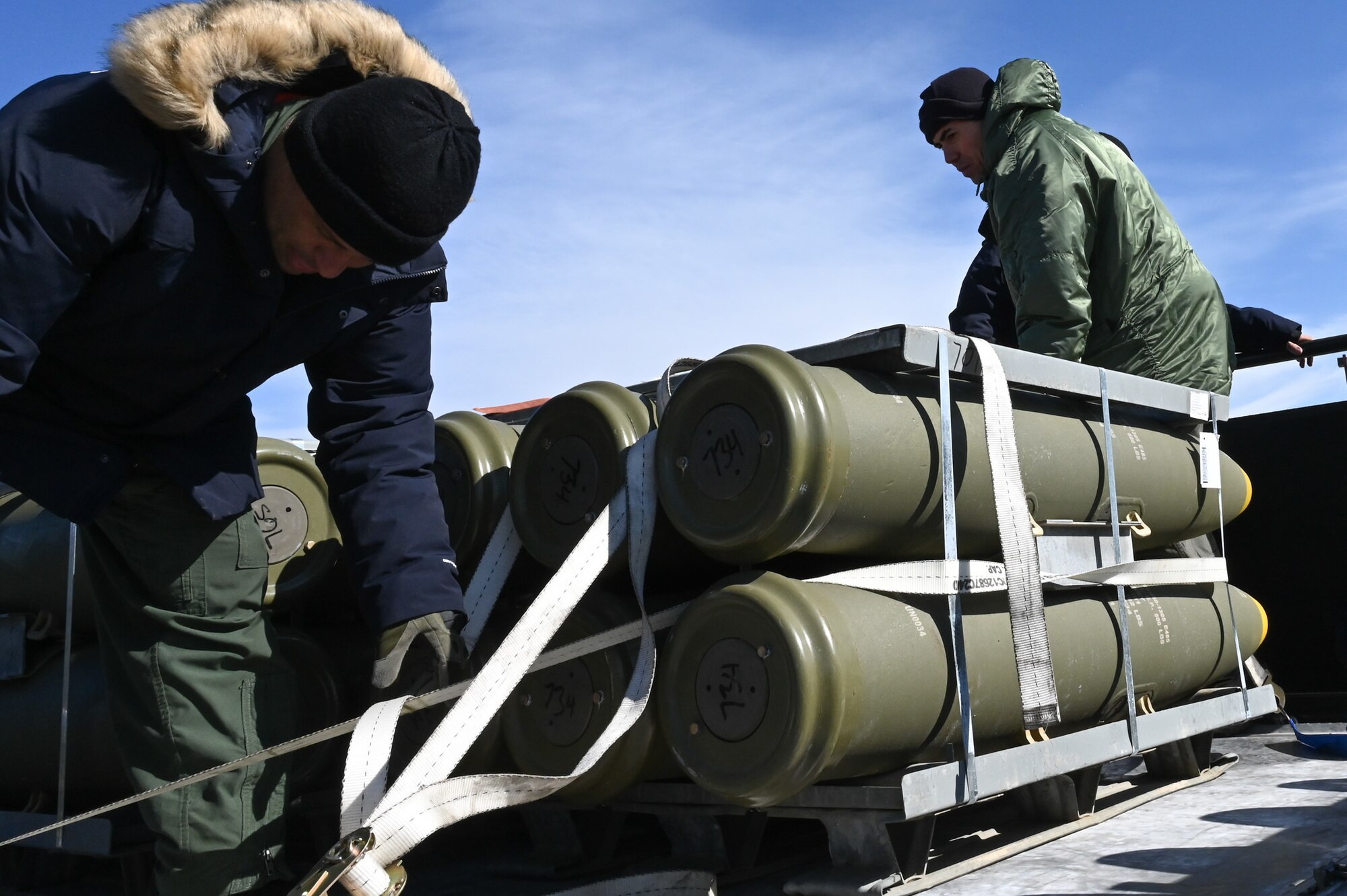 airman tying down munitions