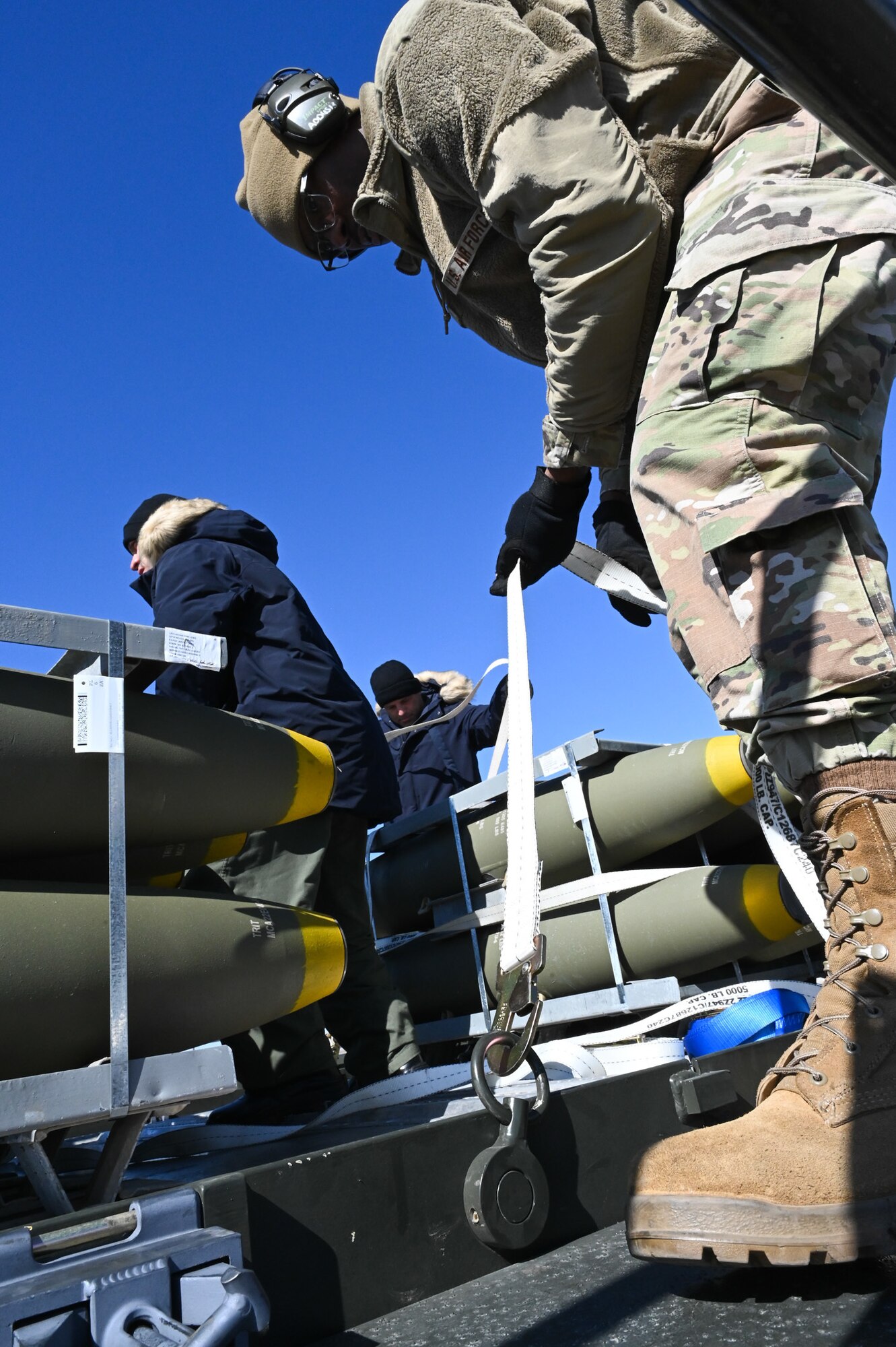 airman tying down munitions