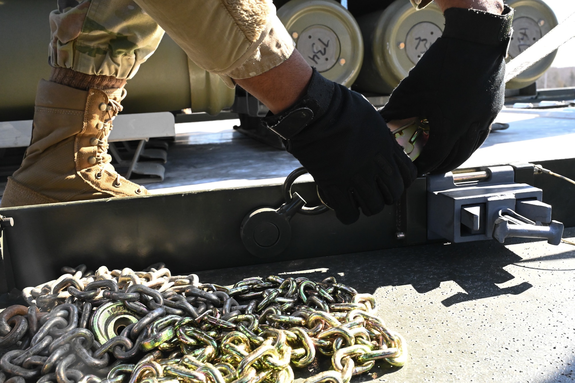 airman tying down munitions